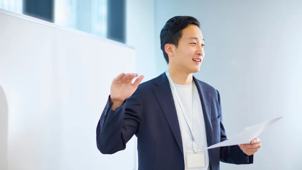 A man presenting in front of a whiteboard