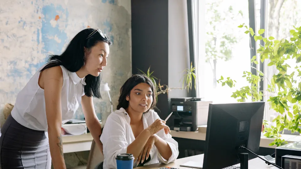 Two women looking at computer